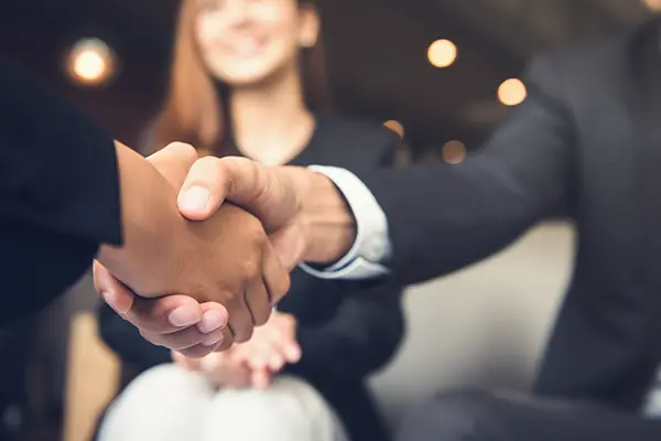 Businessmen shaking hands after meeting cafe