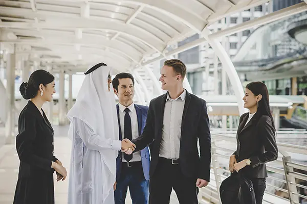 Portrait business partners greeting one another by handshaking